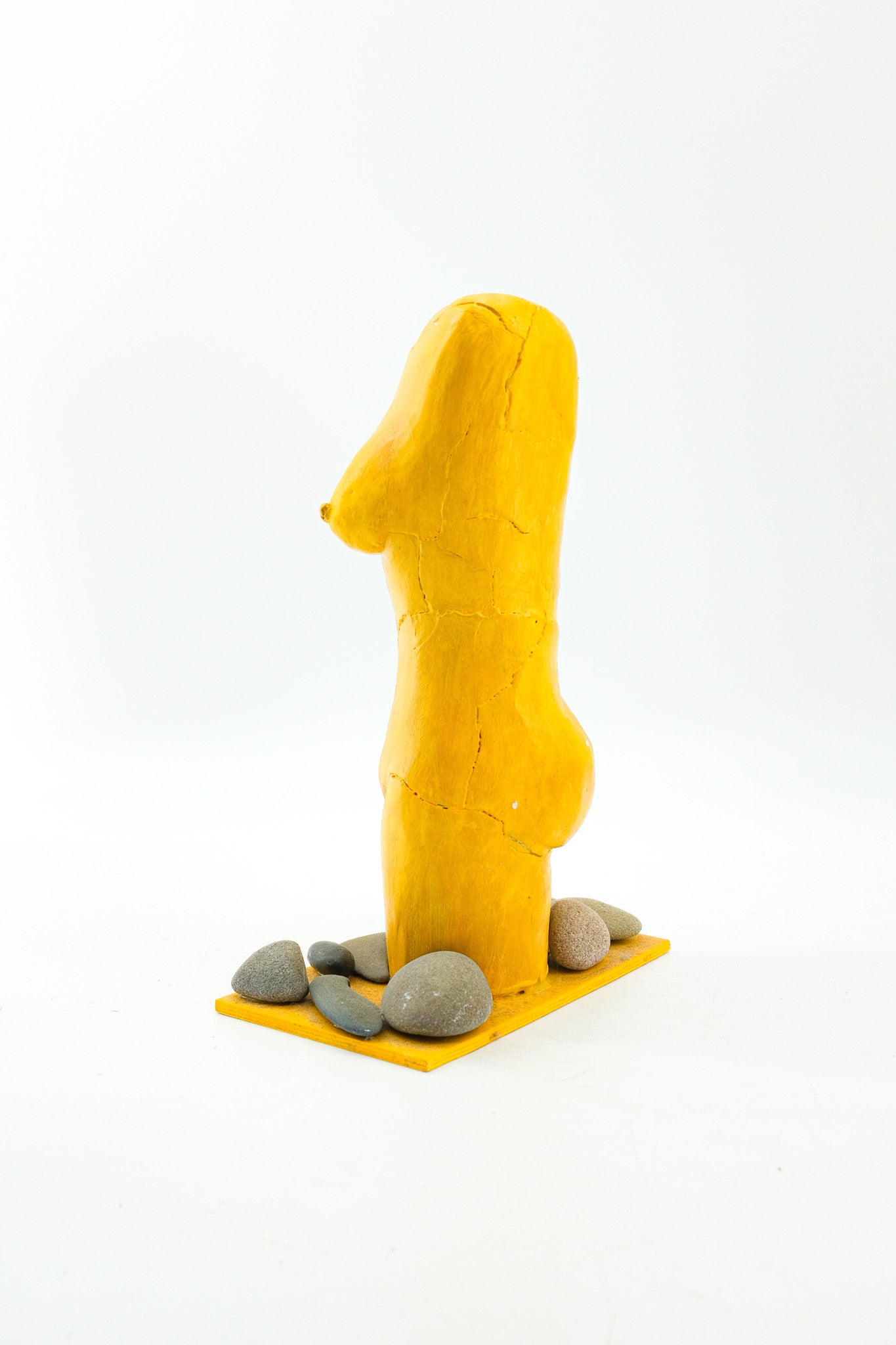 Yellow Female Torso Sculpture with Pebbles / 黄色い裸婦の像