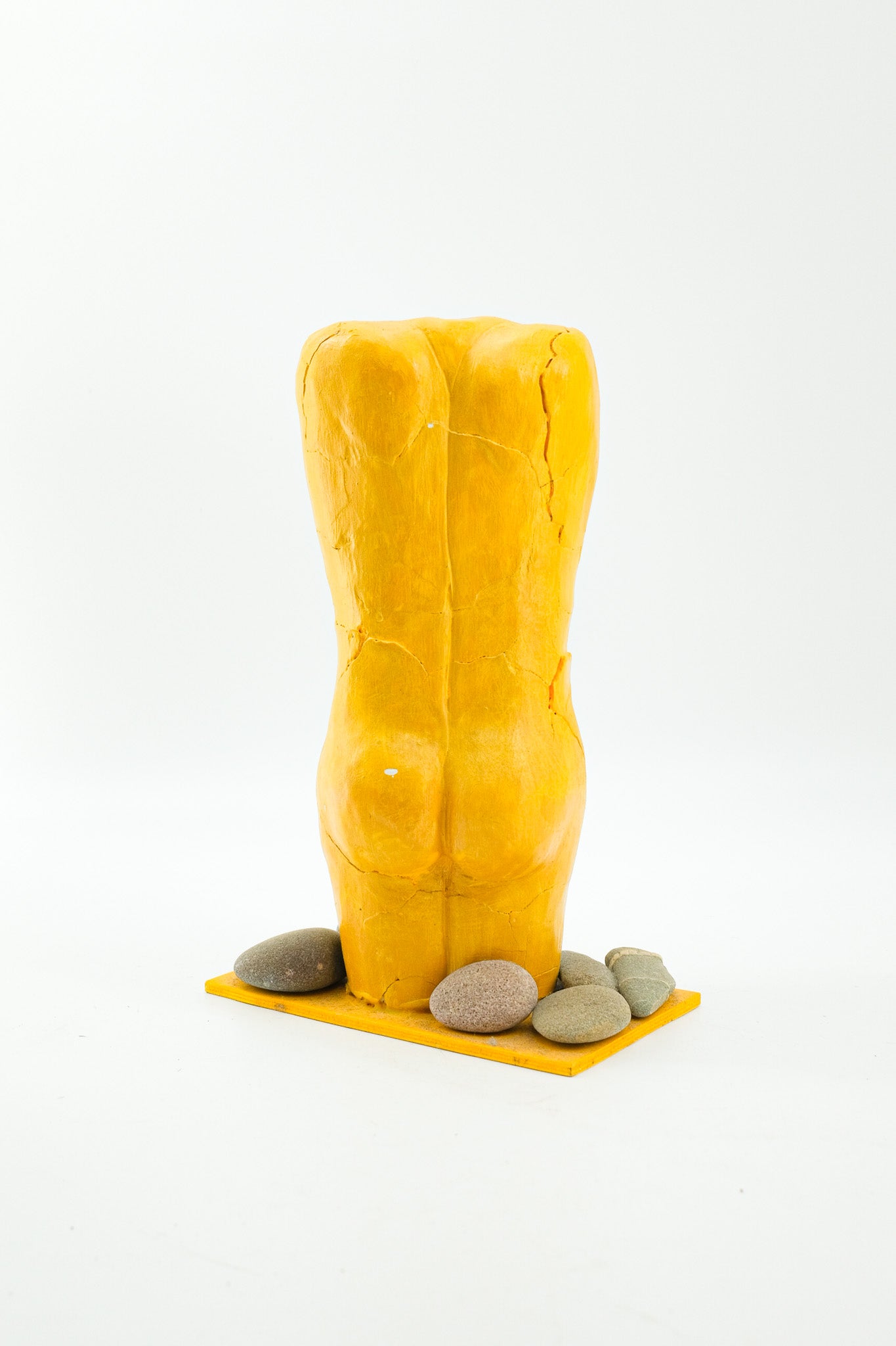 Yellow Female Torso Sculpture with Pebbles / 黄色い裸婦の像